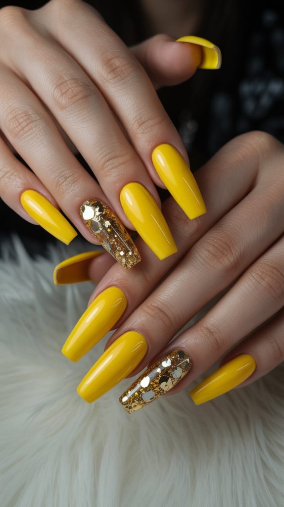 Bold Yellow Nails with Gold Glitter Accents